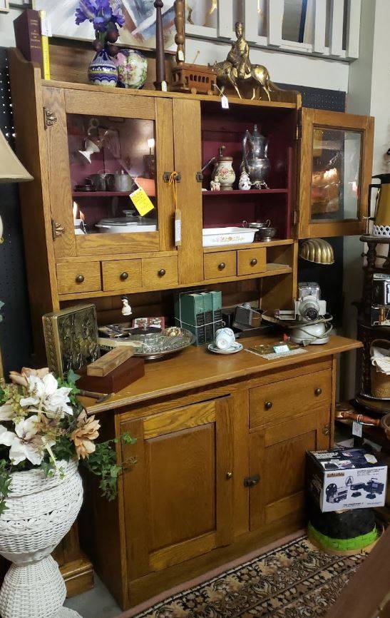 Early 1900s free-standing kitchen cupboard in a medium color wood. he base has two swing-out doors and one drawer. The upper portion is partially recessed from the base, providing an accessible flat surface. The upper piece features to swing-out doors with glass inserts and six small drawers below the doors for additional storage.
Any other items in the photo are available for purchase separately, subject to availability.

Available for viewing without an appointment at Mariposa, 805 Hobson Ave., Hot Springs, AR  71913 during regular business hours. Mariposa is closed on Wednesday.